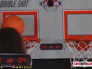 Two attractive girls play a game of strip basketball shootout